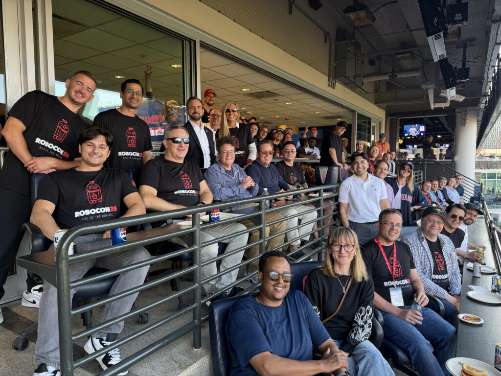 Picture of Robots & Pencils team at baseball game.